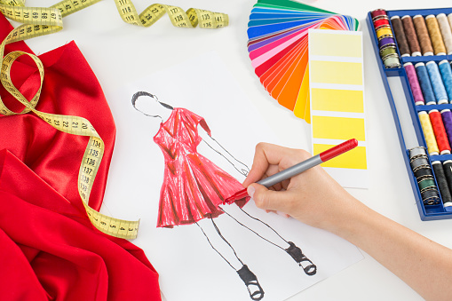 Fashion designer working in studio. Close up design.
